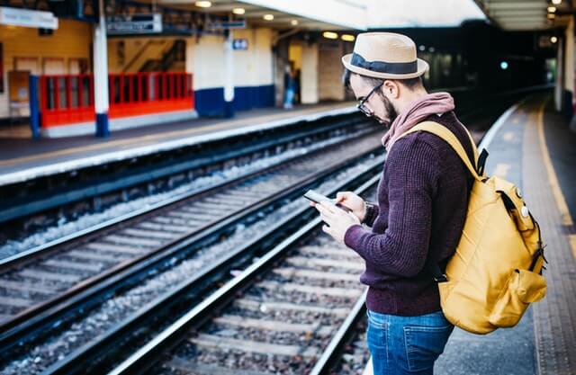 guy on phone at train station